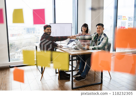 Creative team meeting in modern office setting with sticky notes 118232305