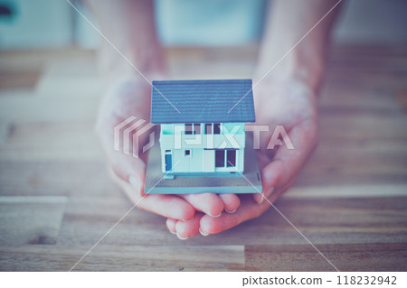 Person holding a house model Person holding a house model 118232942