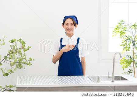 A woman working as a housekeeping service in an apron 118233646