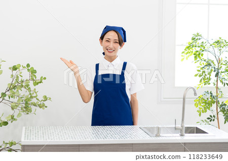 A woman working as a housekeeping service in an apron 118233649
