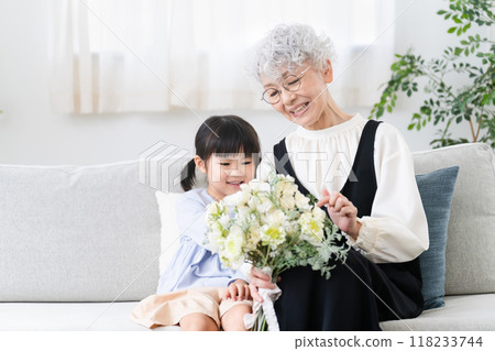 Grandmother and grandson holding a bouquet of flowers Family image 118233744