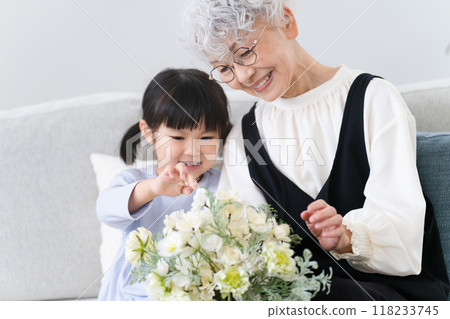 Grandmother and grandson holding a bouquet of flowers Family image Grandmother and grandson holding a bouquet of flowers Family image 118233745