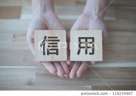 Woman's hand holding the word trust Woman's hand holding the word trust 118234987