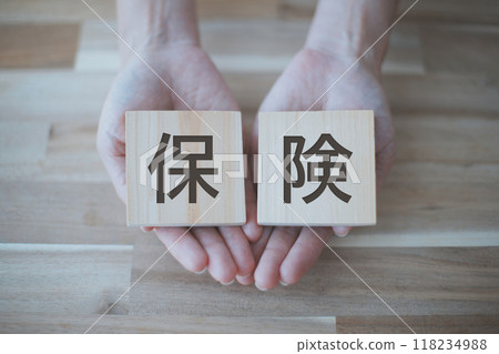 Woman's hand holding the word insurance Woman's hand holding the word insurance 118234988