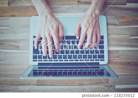 Hands of a woman working on a laptop Hands of a woman working on a laptop 118235012