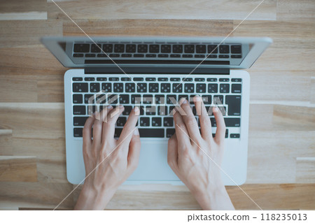 Hands of a woman working on a laptop Hands of a woman working on a laptop 118235013