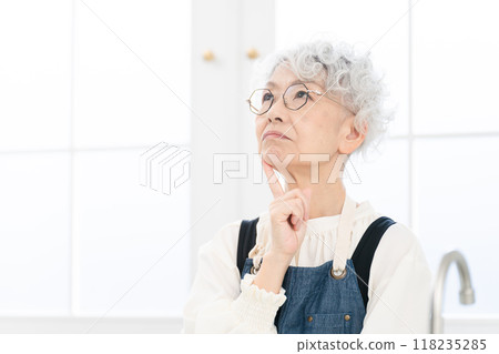 Senior woman standing in the kitchen Cooking image 118235285