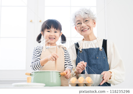 Girl and senior woman standing in the kitchen Cooking image Girl and senior woman standing in the kitchen Cooking image 118235296