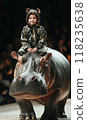 A Child Riding a Hippopotamus at a Unique Fashion Event that Celebrates Imagination and Creativity 118235638