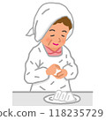 A mother in an apron makes rice balls 118235729