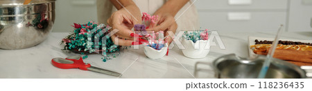 Woman Decorating Candles With Dried Flowers 118236435