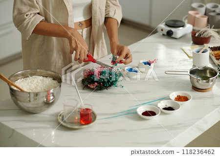 Woman Decorating Candles With Dried Flowers Woman Decorating Candles With Dried Flowers 118236462