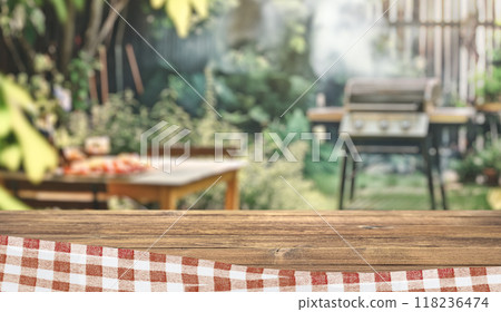 summer time party in backyard garden with grill BBQ, wooden table, blurred background summer time party in backyard garden with grill BBQ, wooden table, blurred background 118236474
