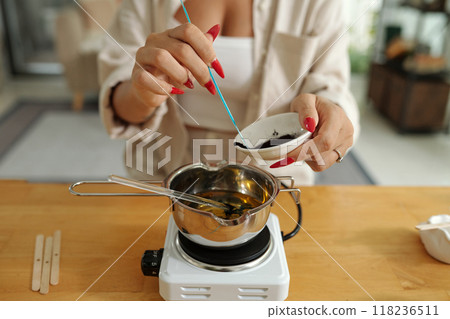 Woman Adding Coloring Material In Wax Woman Adding Coloring Material In Wax 118236511