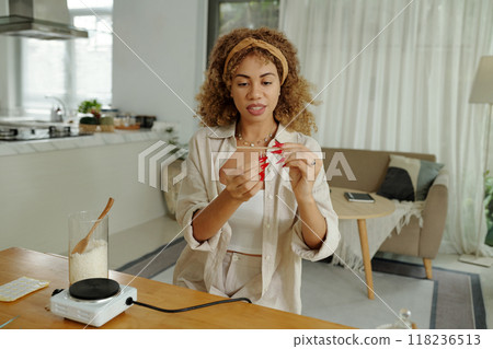 Woman Using Wick To Make Handmade Candles Woman Using Wick To Make Handmade Candles 118236513