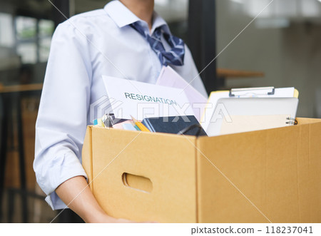 Businessman Leaving Office After Resignation with Box of Belongings 118237041