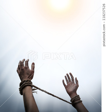 Tied hands raised to the sky 118237526