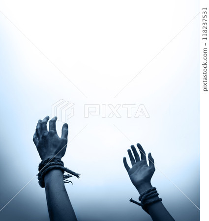 Tied hands raised to the sky 118237531