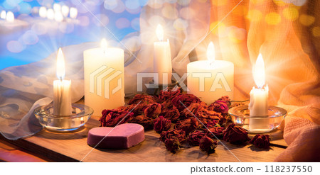 Candles and dried rosebuds on the table Candles and dried rosebuds on the table 118237550