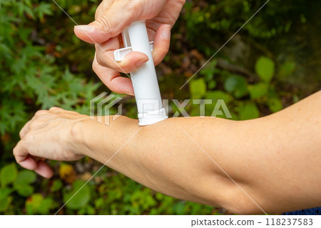Woman's hand sucking poison out of insect bite with poison remover 118237583