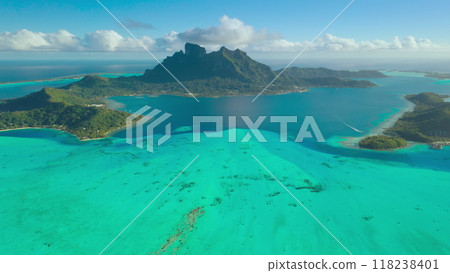 Stunning Bora Bora with its iconic mount otemanu, green islands and turquoise lagoon, creating a picture of perfect tropical paradise. Popular tourist destination. Aerial view drone travel background 118238401