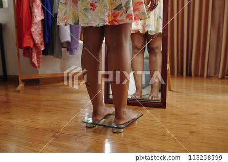Reflecting While Trying On Floral Skirt in Dressing Room Reflecting While Trying On Floral Skirt in Dressing Room 118238599