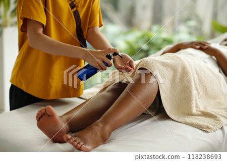 Woman Receiving Relaxing Aromatherapy Massage in Spa 118238693