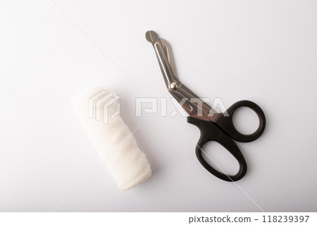 Scissors, bandage on white background top wiev. Treatment wounds. Applying plaster to the fracture. Medical concept banner. Copy space. High quality photo Scissors, bandage on white background top wiev. Treatment wounds. Applying plaster to the fracture. Medical concept banner. Copy space. High quality photo 118239397