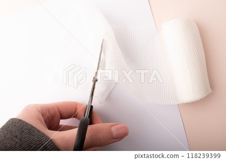 Hand cuts bandage on pink background top wiev. Treatment wounds. Applying plaster to the fracture. Medical concept banner. Healthcare banner. Copy space. High quality photo 118239399