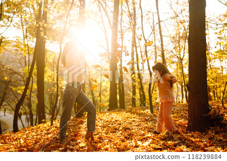 Portrait of happy mother and daughter in autumn forest at sunset. . Autumn women. Portrait of happy mother and daughter in autumn forest at sunset. . Autumn women. 118239884