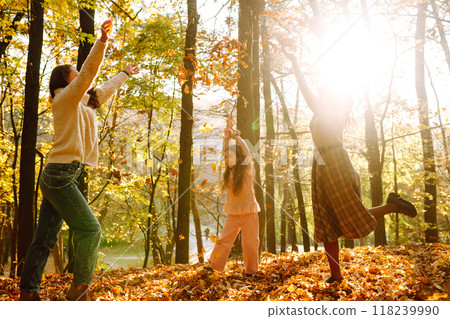The homosexual family playing with her daughter in the autumn forest. The adventure is more fun. 118239990