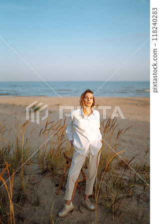 Stylish woman enjoying autumn weather outdoor. Fashion, style concept. People, lifestyle, relaxation 118240283