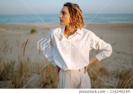 Stylish woman enjoying autumn weather outdoor. Fashion, style concept. People, lifestyle, relaxation 118240284