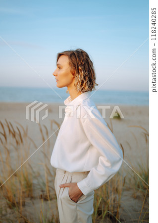 Stylish woman enjoying autumn weather outdoor. Fashion, style concept. People, lifestyle, relaxation 118240285