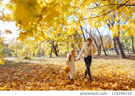 Young Mother and daughter walking in the park and enjoying the beautiful autumn nature. Walk, family 118240314