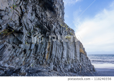 Towering Basalt Cliffs at Reynisfjara Black Sand Beach. Towering Basalt Cliffs at Reynisfjara Black Sand Beach. 118240356