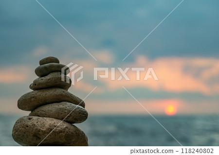 Stone Cairns Beach Ocean - Three stone cairns stacked on a sandy beach by the ocean. Stone Cairns Beach Ocean - Three stone cairns stacked on a sandy beach by the ocean. 118240802