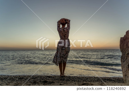 Woman Beach Sunset Silhouette at the beach during sunset. 118240892