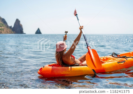 Kayak sea woman. Happy attractive woman with long hair in red swimsuit, swimming on kayak. Summer holiday vacation and travel concept. Kayak sea woman. Happy attractive woman with long hair in red swimsuit, swimming on kayak. Summer holiday vacation and travel concept. 118241375