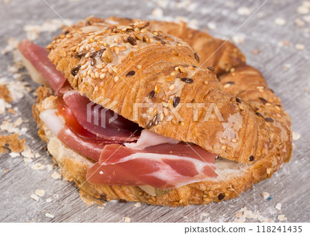 Sandwich made with croissant cheese and Parma ham Sandwich made with croissant cheese and Parma ham 118241435