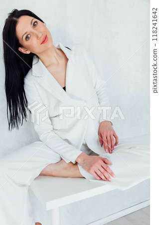 Beautiful slim fashion brunette woman in white business suit 118241642