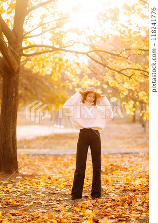 Stylish woman enjoying autumn weather in the park. Fashion, style concept. 118241776