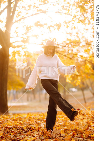 Stylish woman enjoying autumn weather in the park. Fashion, style concept. 118241778