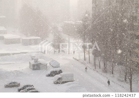 Urban landscape in blue colors in heavy snowfall, blizzard, snowstorm on street. 118242437
