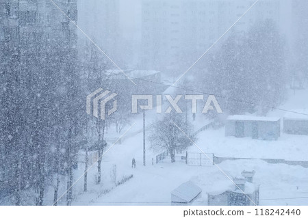 Urban landscape in blue colors in heavy snowfall, blizzard, snowstorm on street. Urban landscape in blue colors in heavy snowfall, blizzard, snowstorm on street. 118242440