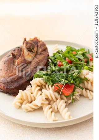 Enjoy a hearty meal with turkey paired with gluten-free pasta and a fresh salad of seasonal vegetables and herbs, complemented by ripe fruits for a balanced and nutritious breakfast 118242953