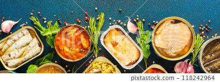 Enjoy an assortment of canned fish including salmon, mackerel, sprat, sardine, tuna, herring, and fish pate, displayed in open tins with spices and herbs , banner 118242964
