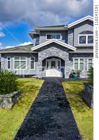 Nice residential house with stone texture walls and stone walls on front yard 118243191