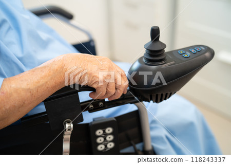 Asian senior woman patient on electric wheelchair with remote control at hospital, healthy strong medical. 118243337