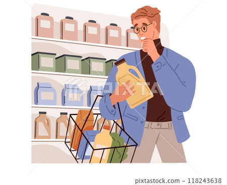 A man wearing glasses is shopping for detergent in a grocery store, examining a bottle while standing in front of shelves filled with various cleaning products. Decision-making in retail shopping. 118243638